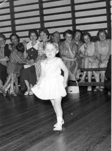Birgit til danseskole i Borum Forsamlingshus 1960. Bemærk ribberne i salen på gavlvæggen mod vest og de cigaretrygende mødre i baggrunden